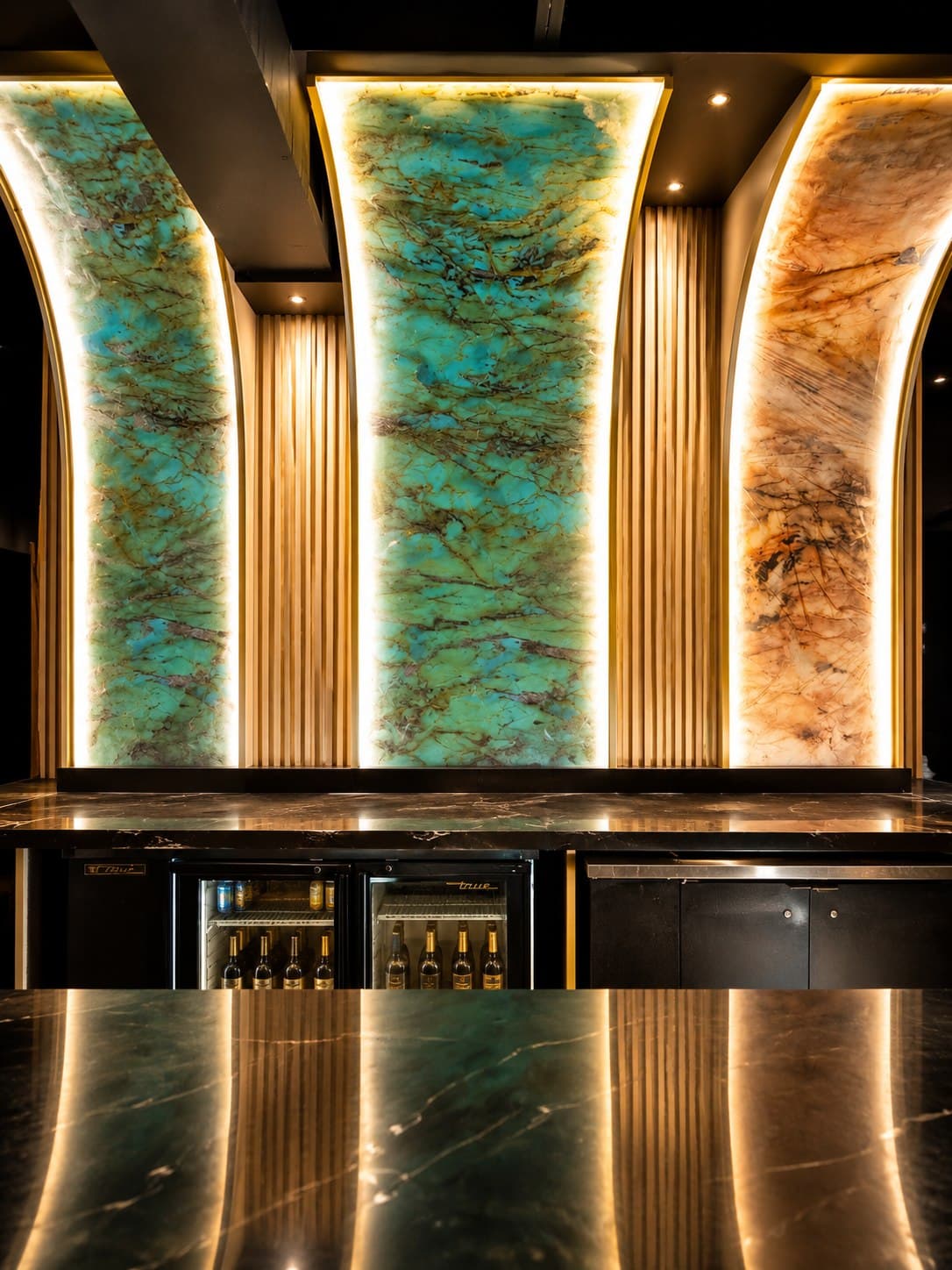 Illuminated onyx back bar and marble bar counter at Barzilla